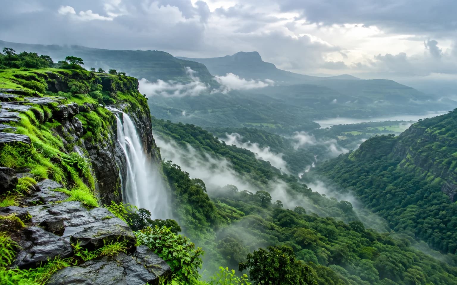 Misty green Sahyadri valley and seasonal waterfall near Lonavala